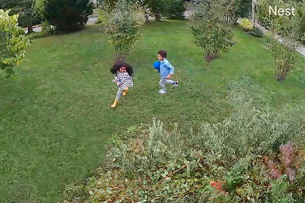 Nest video image of two kids playing in backyard Nest video image of two kids playing in backyard
